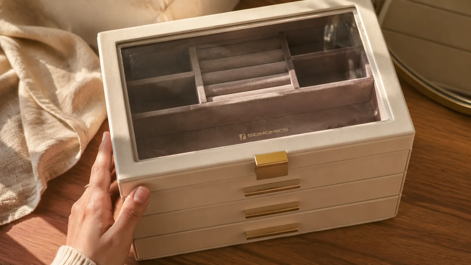 Close-up of fingerprints visible on the glass lid of the jewelry box after a day of use
